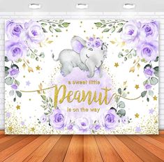 an elephant is sitting on top of a wall with purple flowers and stars around it