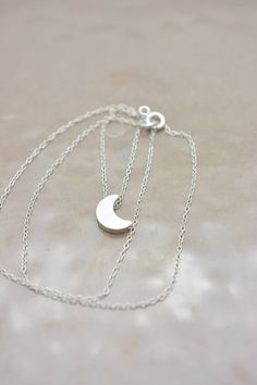 This lovely necklace makes a beautiful, lasting gift. I make this using 925 sterling silver chain and spring clasp. The crescent moon charm is a metal alloy with shiny silver finish and measures approximately 1/2 inch tall. It moves freely along the chain. Comes in a gift box, perfect for gift-giving. This piece looks great when paired with a star necklace. See 5th photo for both necklaces together. Listing is for moon necklace only but star necklace can be purchased here: www.etsy.com/listing/2 Silver Crescent Moon Phase Charm Necklace, Sterling Silver Half Moon Charm Necklace, Sterling Silver Crescent Moon Charm Necklace, Silver Crescent Sterling Silver Charm Necklace, Silver Dainty Moon Charm Necklace, Silver Moon Charm Necklace With Adjustable Chain, Silver Half Moon Charm Necklaces, Silver Half Moon Charm Necklace, Dainty Silver Necklace With Moon Charm