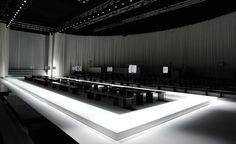 an empty room with chairs and lights on the floor