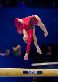 a person on the balance beam doing a trick