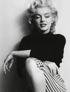 black and white photograph of marilyn monroe sitting on the floor