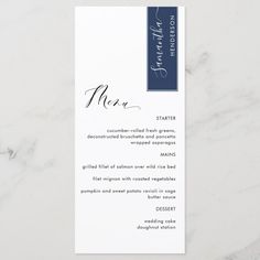 a white and blue menu card on a marble surface