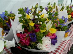 colorful flowers are sitting on the table at an outdoor event, ready to be eaten