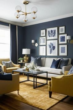 a living room filled with furniture and pictures on the wall above it's coffee table