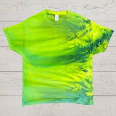 a t - shirt with green and yellow paint on it