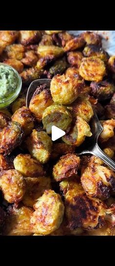 a plate full of fried food with dipping sauce