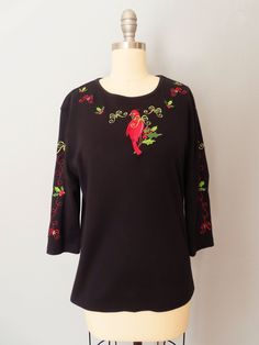 a black top with red birds on it