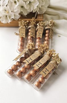 some brown eggs are in plastic containers on a table next to flowers and a wooden box