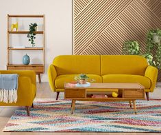 a living room with yellow couches and colorful rugs on the floor in front of a wooden shelving unit