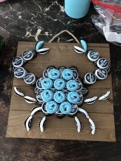 a crab made out of cupcakes sitting on top of a wooden board