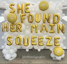 there is a sign that says she found her main squeezee in gold foil balloons