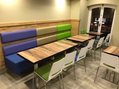 an empty cafeteria with tables and chairs in the middle, waiting for customers to arrive