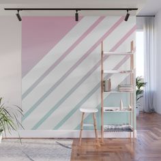 a living room with pink, blue and white stripes on the wall next to a chair