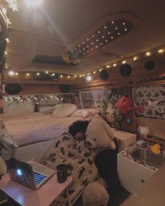 a man sitting in the back of a bus with a laptop computer