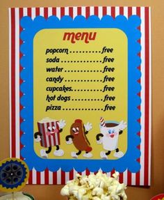 a table topped with lots of food next to a sign that says menu for popcorn