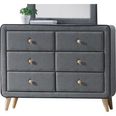 a grey dresser with drawers and a mirror on it's top shelf next to a potted plant