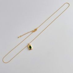 Add a touch of elegance to any outfit with our Emerald Necklace. Featuring a brilliant green CZ stone and multiple layers of 14k gold plating, this 18" necklace is both waterproof and anti-tarnish for everyday wear. Perfect for any occasion. Gold Minimalist Emerald Necklace With Clavicle Chain, Dainty Gold-plated Emerald Necklace, Gold Emerald Necklace With Adjustable Chain For May Birthstone, Elegant Everyday Gold Emerald Necklace, Everyday Elegant Gold Emerald Necklace, Elegant Gold Emerald Necklace For Everyday, Everyday Green Gold Plated Jewelry, Green Gold-plated Everyday Jewelry, Everyday Green Gold-plated Jewelry