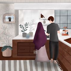 a man and woman are standing in the kitchen looking at something on the counter top