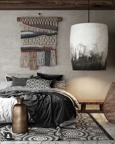 a bedroom with a bed, rugs and pictures hanging on the wall above it