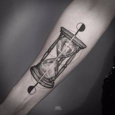 an hourglass tattoo on the arm