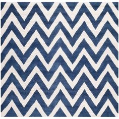 a blue and white rug with large chevrons on the bottom in various sizes