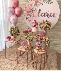 a table topped with lots of pink and yellow flowers next to a sign that says ciara