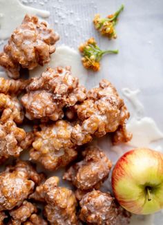 apples and walnuts are on a plate next to an apple