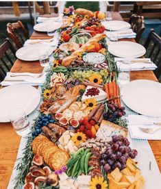 a long table covered with plates and bowls filled with food