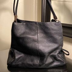 Coach - Black Madison Phoebe Leather Hobo Slouchy Handbag Gently Used. Excellent Condition. It Is Made Out Of Buttery, Soft Pebbled Leather. The Inside Is Lined With A Royal Blue Satin Fabric. This Bag Would Be Perfect For Everyday Use. Original Price Was $328. Approximate Measurements: L 12.5" X W 5.75" X H 11.5" Approximate Handle Drop: 11" Interior Details: 3 Main Compartments Compartments Include: Center Section With Zip Closure, 1 Zip Pocket, 2 Multifunction Pockets Additional Details: Magnetic Snap Closure, Gold Hardware Note: I Make Effort To Describe The Conditions Of My Items As Accurately As Possible, But Please Expect Normal Signs Of Wear Associated With Used Items. Th Chic Coach Textured Leather Hobo Bag, Chic Textured Leather Coach Hobo Bag, Versatile Coach Bags In Soft Leather, Versatile Coach Soft Leather Bag, Coach Black Crossbody Hobo Bag, Coach Black Hobo Bag For Daily Use, Black Coach Hobo Bag For Travel, Coach Black Bucket Shoulder Bag, Coach Textured Leather Evening Bag