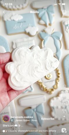 someone is holding some cookies in their hand and it looks like they have been decorated with white icing