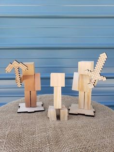 three wooden sculptures sitting on top of a table