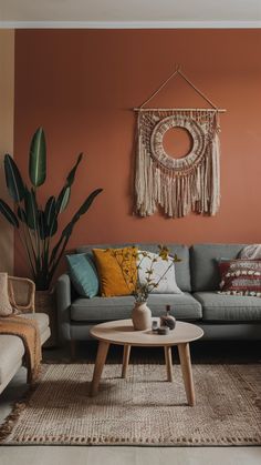 a living room filled with furniture and a potted plant on top of a table