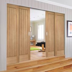 the interior of a house with wooden floors and sliding doors in it's center