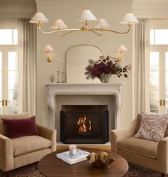 a living room filled with furniture and a fire place in the middle of a room