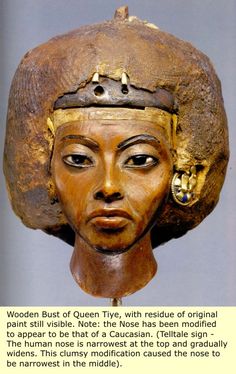 the head of an ancient egyptian woman wearing a helmet with gold decorations on it's forehead