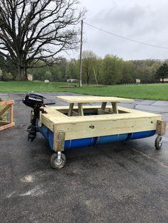 a trailer with two picnic tables attached to it in the middle of a parking lot