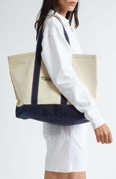 A sturdy cotton tote sports the brand's logo and is a perfect companion for beach days. Top carry handles Interior wall pocket 100% cotton Dry clean or machine wash, line dry Imported Asian & Pacific Islander Owned/Founded Casual Cotton Canvas Bag For Weekend, Blue Cotton Canvas Bag For Weekend, Sporty Rectangular Cotton Bag, Navy Cotton Canvas Bag For Everyday, Sporty Cotton Canvas Travel Bag, Everyday Navy Cotton Canvas Bag, Sporty Cotton Bags For Daily Use, Casual Canvas Travel Bag With Embroidered Logo, Casual Canvas Bag With Embroidered Logo For Travel