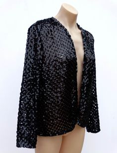 VINTAGE JET BLACK CROCHET SEQUIN JACKET BLAZER Incredible 1980's vintage sequin jacket. Black acrylic crocheted squares with black sequins throughout. (the jacket is done in a pattern of squares leaving every other one exposed or open so you can see through the jacket.) Long sleeves. Cropped length. No fastenings - sits open like a cardigan.  Acrylic Label: PEER GYNT Sydney Australia. Size - S-M/10-12 (shoulder to shoulder lying flat is 43cm/17 inches, armpit to armpit lying flat is 56cm/22 inches, length is 56cm/22 inches from shoulder, sleeve length is 53cm/21 inches - any questions on sizing please ask if you're not sure!) Fabric is not stretchy. Excellent vintage condition - please see photos for best description. This is a total rare gem! Please be aware that vintage items may have im Winter Outerwear With Sequins, Vintage Black Outerwear For Party, Fitted Sequin Cardigan For Party, Fitted Sequined Cardigan For Parties, Vintage Sequin Outerwear For Night Out, Long Sleeve Sequined Evening Cardigan, Fitted Sequin Evening Cardigan, Vintage Winter Outerwear With Sequins, Black Sequin Long Sleeve Blazer