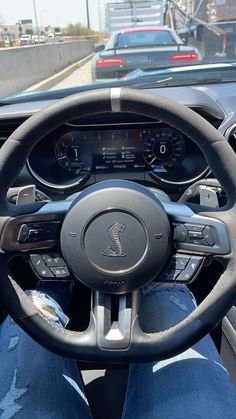 the interior of a car with steering wheel and dashboard