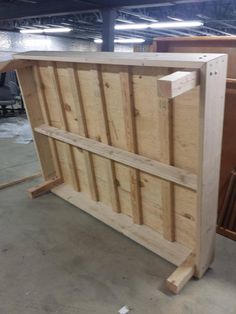 an unfinished counter made out of wood in a garage