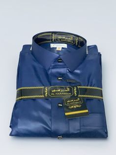 Magnificent satin Qamis with pretty square metal snap buttons matching the Qamis. With a shirt collar and buttoned sleeves, this satin kamiss is very elegant. Featuring 2 pockets and a slot for your cell phone to fit in your pocket. There is also a small slot for a pen in the pocket on the chest. Available in several sizes. Blue Formal Thobe For Eid, Festive Formal Thobe With Dabka, Formal Festive Thobe With Dabka Detailing, Festive Formal Thobe With Dabka Detailing, Formal Long Sleeve Thobe For Eid, Formal Abaya For Eid, Muslim Men, Shirt Collar, Cell Phone