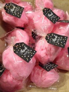 pink cotton candy wrapped in plastic bags with black and gold polka dots on the top