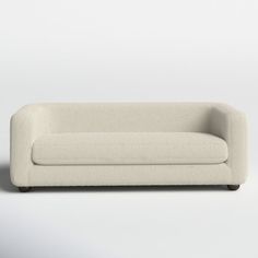 a white couch sitting on top of a white floor