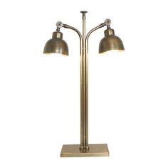 an antique brass lamp with two lamps on each side and one light on the other