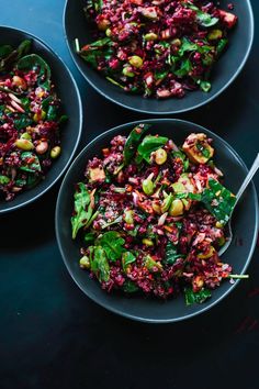 three black bowls filled with food on top of a table