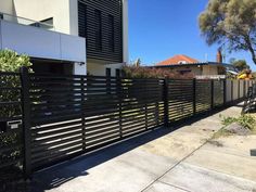 a black fence in front of a house