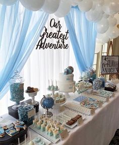 the dessert table is decorated with blue and white balloons