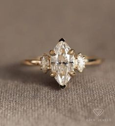 an engagement ring with three pear shaped diamonds