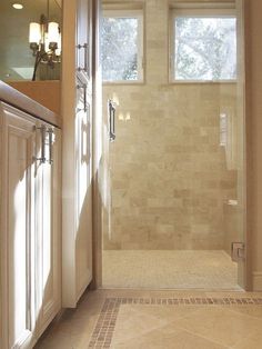 a bathroom with a walk in shower next to a sink