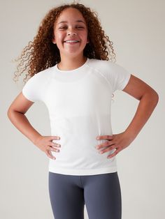 FOR: School, practice and play FEEL: Non-chafing seamless fabric is stretchy and comfortable FAVE: Keeps her comfy for all activities Skims easily over the body Body length in size medium: Regular: 20.5". White Workout Outfit, Fitness Wear Women, Athleta Shorts, Seductive Clothes, Athletic Top, Workout Outfit, Workout Wear, Girl Power, Leotards